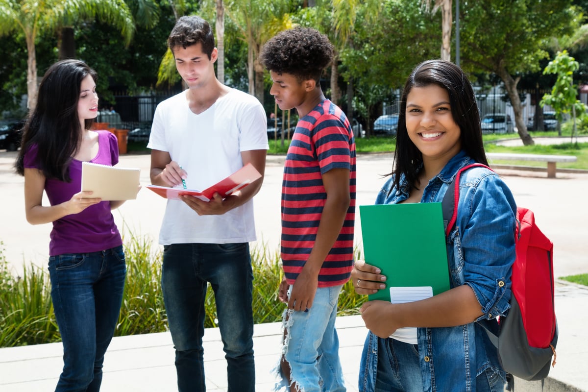 Native latin american female student with group of other international students